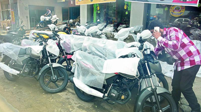 An employee of a city showroom inspects newly arrived BS-IV two-wheelers after they were unloaded from a truck in the city on Wednesday. (photo: DC)