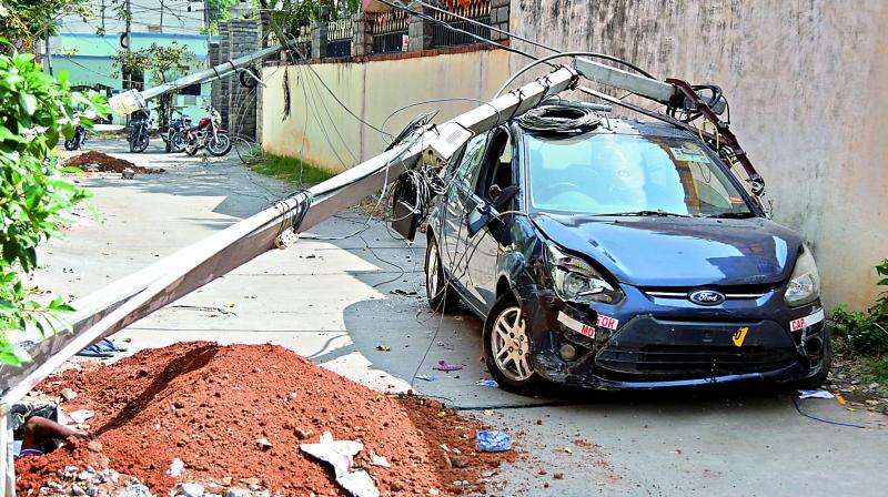 A damaged car is parked at the accident site at Ampro Colony, Karmanghat in Hyderabad on Wednesday. 	(Photo: DC)