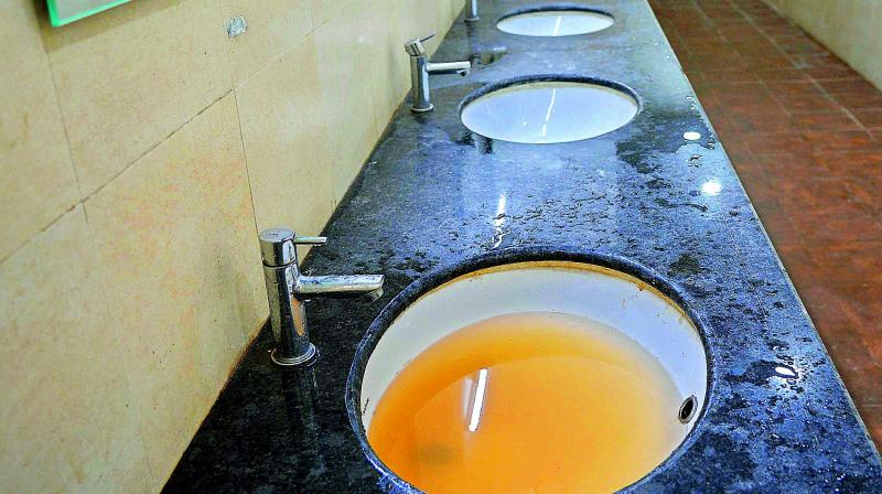 Water remains in the sink due to blockage in the washroom of AP Secretariat at Velagapudi on Thursday. 	(Photo: DECCAN CHRONICLE)