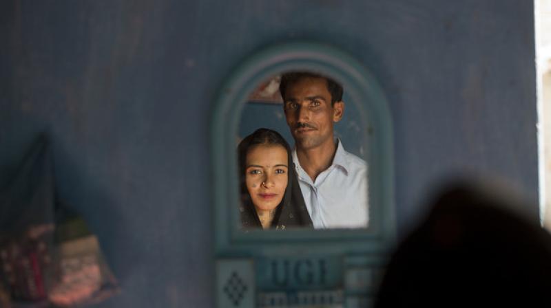 Hamid Brohi poses for a picture with his wife Jeevti at their home in Pyaro Lundh, Pakistan. (Photo: AP)