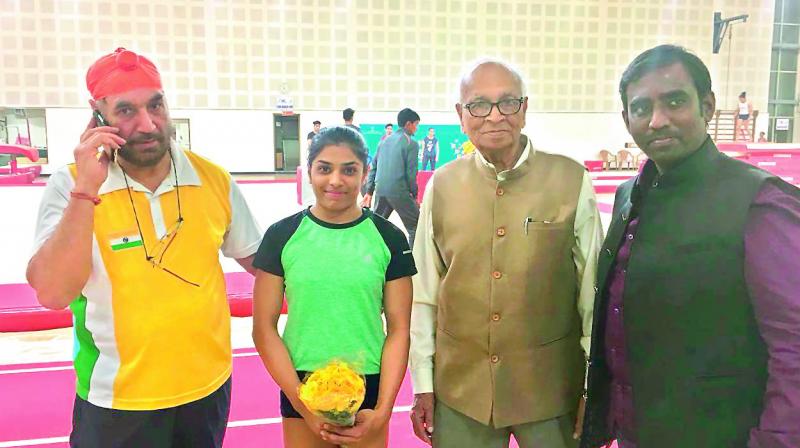 Gymnastics World Cup bronze medallist Budda Aruna Reddy (second from left) is flanked by Gymnastics Federation of India chief coach Gurdial Singh Bawa (left), Olympic Association of Telangana president K. Ranga Rao (second from right) and Gymnastics Association of Telangana secretary K. Maheswar (right) at the Indira Gandhi Indoor Stadium in New Delhi on Wednesday evening.