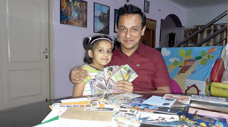 Rohit Kamath poses with his post card collections