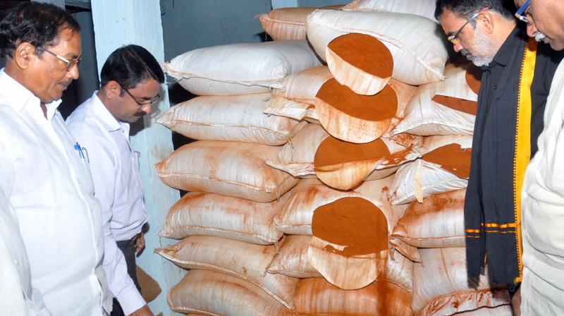 Guntur Agriculture Yard chairman M. Subba Rao, along with other officials, checks spurious chili powder at various chilli powder manufacturing units and cold storages  in Guntur on Thursday. (Photo: DC)