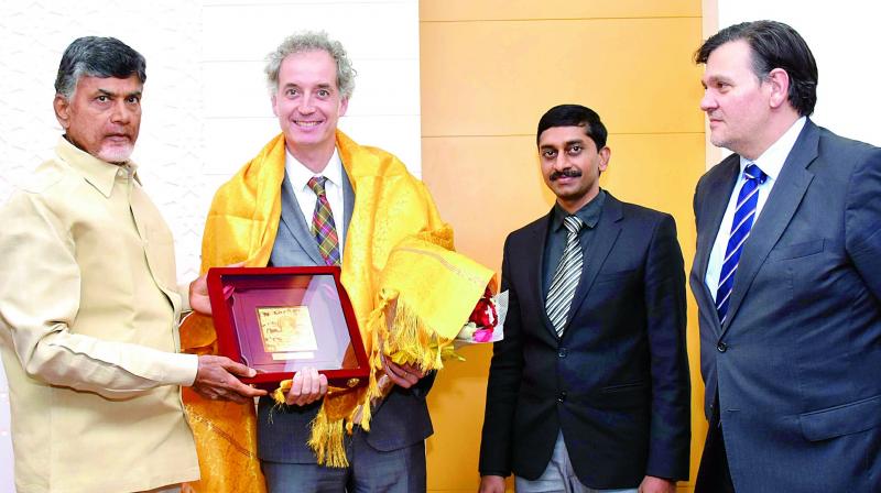 Chief Minister N. Chandrababu Naidu felicitates to Spain delegates at the CMs Camp Office in Vijayawada on Thursday. (Photo: DC)
