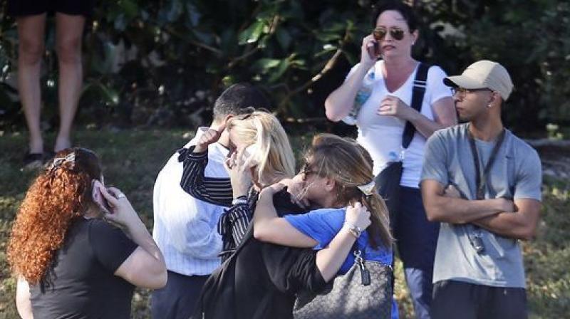 Parents wait for news after a reports of a shooting at Marjory Stoneman Douglas High School in Parkland. (Photo: AP)