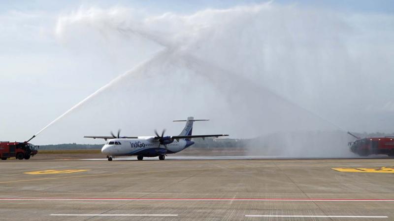 Fire tender units give water salute to the Indigo passenger flight at Kannur International Airport on Friday.