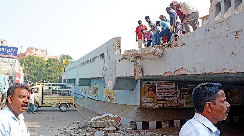 The broken parapet wall of the Anna flyover after the tipper lorry nosedived into the service lane below on Tuesday (Photo: DC)