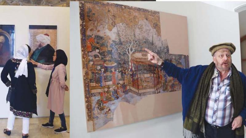 Visitors (left) walk past a display of Mughal paintings at the  King Baburs Kabul, Cradle of the Mughal Empire  exhibition in Kabul.  American historian Michael Barry gestures during an interview	(Image: AFP)