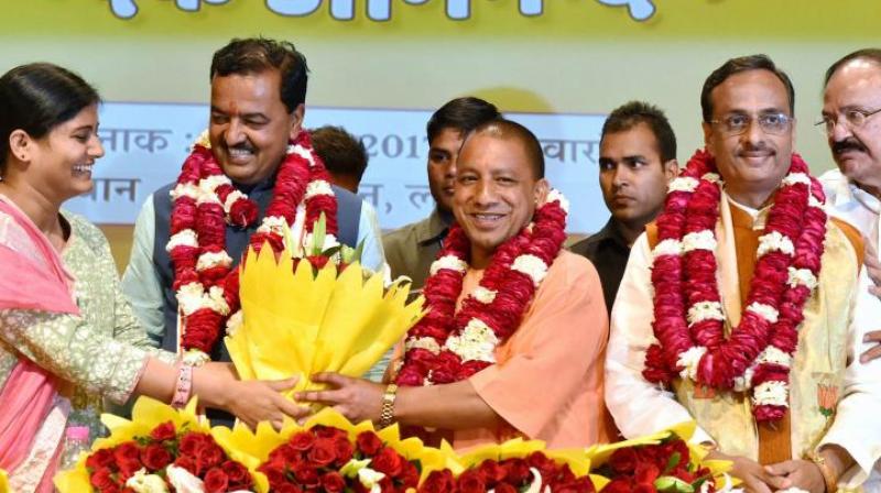 Union minister of state for health and family welfare and Apna Dal leader Anupriya Patel greets BJPs Yogi Adityanath (C) elected leader of the BJP Legislature Party, K.P. Muriya (L Deputy CM) and Dinesh Sharma (R Deputy CM) in Lucknow on Saturday. (Photo: PTI)