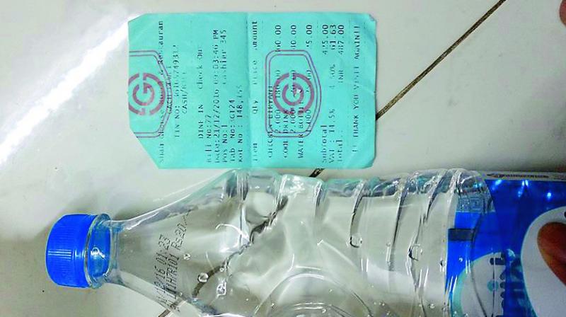 Picture of the bill where the cost of bottled water was hiked above the MRP.