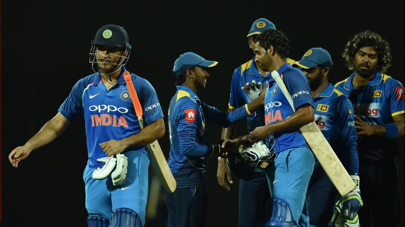 Despite a valiant effort by Akila Dhananjaya, India managed to limp over the finish line, with the watchful Mahendra Singh Dhoni and Bhuvneshwar Kumar at the crease. (Photo: AP)