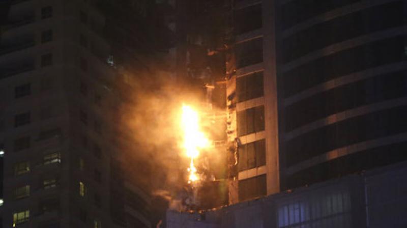 A fire broke out after midnight Friday in one of the worlds tallest residential towers in Dubai, engulfing part of the skyscraper and sending chunks of debris plummeting below. (Photo: AP)