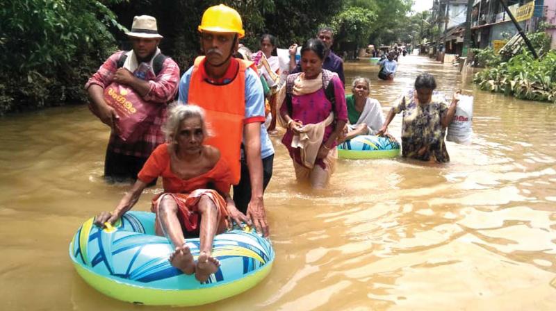 Elderly immobile women being moved to safely by Thanal volunteers.