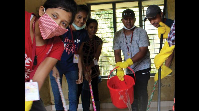 Civil service aspirants wash Kainakary Panchayat Office on Thursday as part of their week-long clean up drive in flood ravaged places in Kerala.