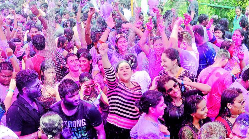 Revelers enjoy the Rain Dance event as part of Holi festival at a hotel in Visakhapatnam on Monday. (Photo: DC)