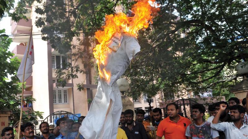 DYFI members burn M. Vincent, MLA, in effigy in front of the MLA quarters in Thiruvananthapuram on Saturday. (Photo: DC)