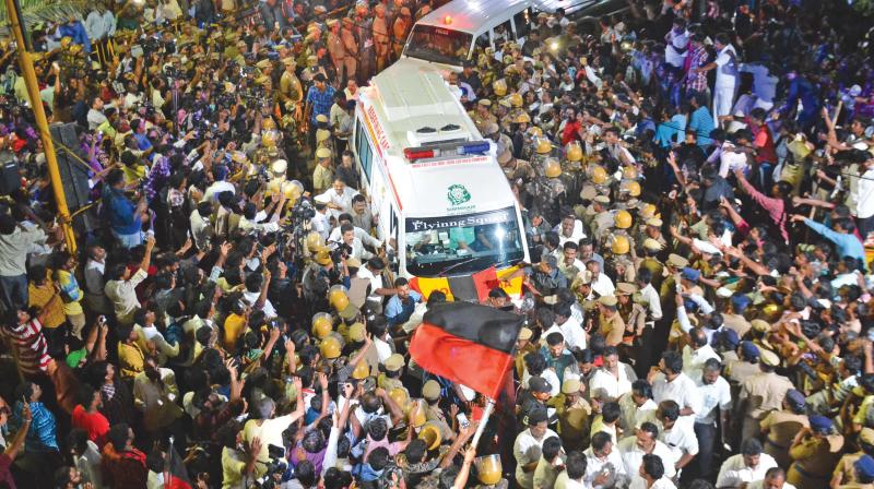 As the ambulance carrying the departed leaders body leaves Kauvery hospital, DMK cadres gather around the vehicle to have a peep at his face (Photo: DC)