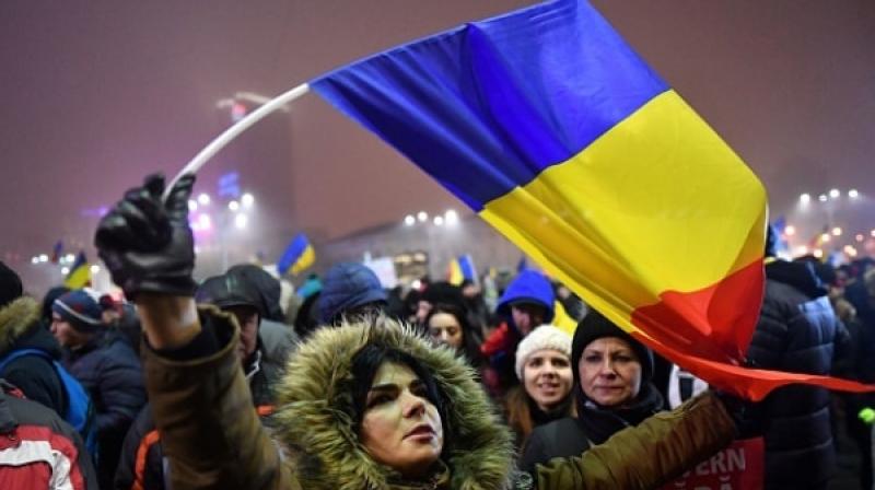Protestors protest on Mondat might in Bucharest, a day after the Romanian government repealed an emergency decree that would have turned a blind eye toward political corruption. (Photo: AFP)