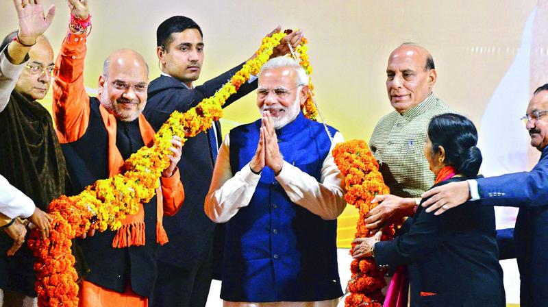 Prime Minister Narendra Modi is being felicitated by senior party leaders  finance minister Arun Jaitley, party chief Amit Shah, home minister Rajnath Singh and external affairs minister Sushma Swaraj  at the party headquarters in New Delhi on Monday after the party emerged victorious in Gujarat and Himachal Pradesh polls. (Photo: AP)