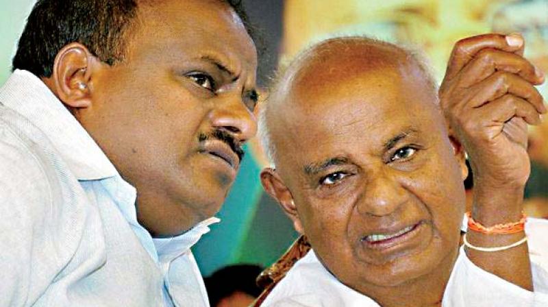 JD(S) state president H.D. Kumaraswamy and party supremo and former PM H.D. Deve Gowda in a file photograph.
