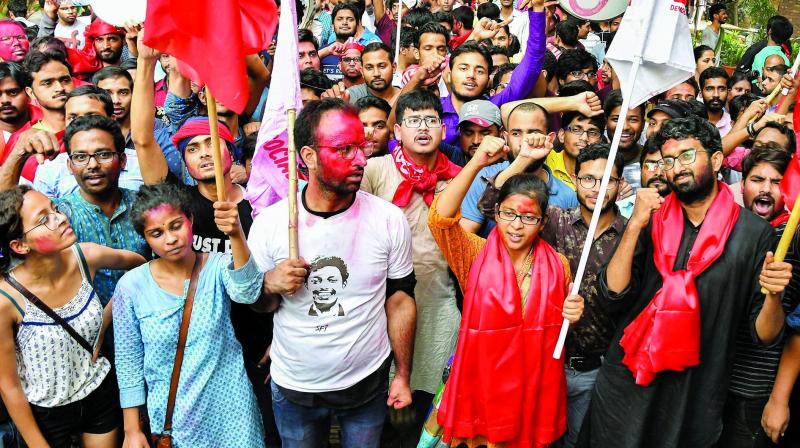 Members of Left Unity celebrate after their success in JNUSU elections, in New Delhi, Sunday. 	(Photo: PTI)