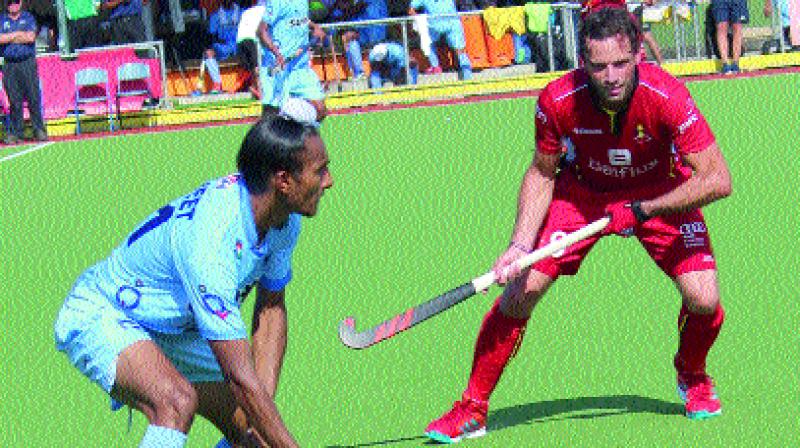 Harjeet Singh in action against a Belgium midfielder in the final of the four-nations hockey tournament.