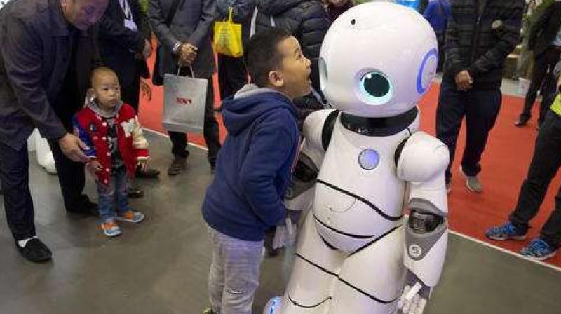 In this Friday, Oct. 21, 2016 photo, a Chinese boy shouts into the Canbot, a companion robot, displayed during the World Robot Conference in Beijing, China. China is showcasing its burgeoning robot industry as it seeks to promote use of more advanced technologies in Chinese factories and create high-end products that redefine the meaning of \Made in China.\ The Canbot can dance and respond to voice commands, while others can play badminton, sand cell phone cases and sort computer chips. (AP Photo/Ng Han Guan)  Read more at: http://phys.org/news/2016-10-robots-center-china-strategy-leapfrog.html#jCp