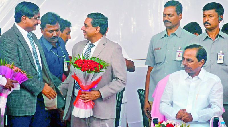 Outgoing Chief Secretary Rajiv Sharma greets his successor K. Pradeep Chandra as Chief Minister K. Chandrasekhar Rao looks on, at a public function in the Secretariat premises in Hyderabad on Wednesday.  (Photo: DC)