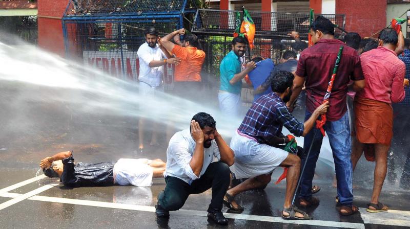 Police uses water cannon to disperse the Yuva Morcha activists during their protest march to the Police Commissioners Office in Kozhikode on Thursday. (Photo:  DC)