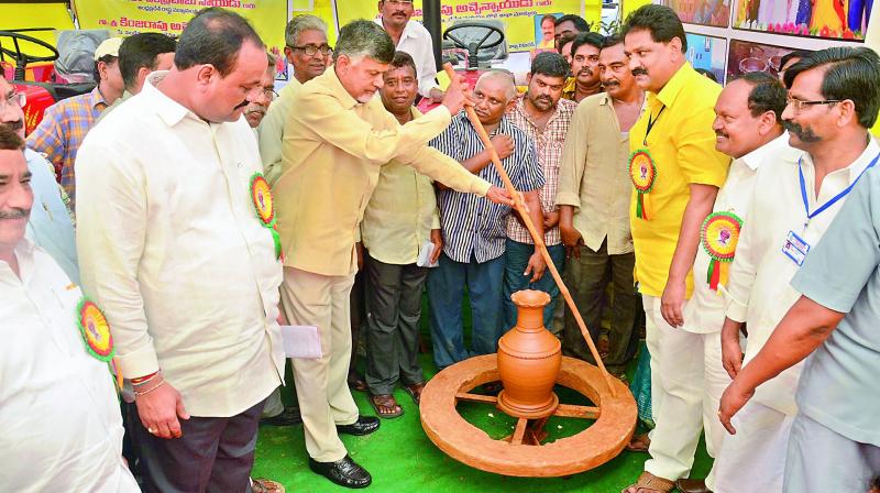 Chief Minister N Chandrababu Naidu tries his hand in making pottery as he goes around the exhibition of stalls at the birth anniversary celebrations of social reformer Jyothirao Pule at AU Convocation Hall in Visakhapatnam on Tuesday. (Photo: DC)