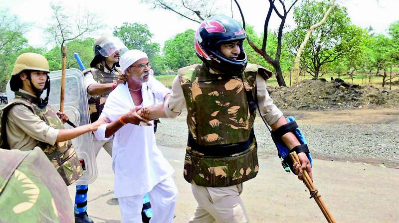 Police detain one of the many farmers who was pelting stones in Phanda near Bhopal on Friday. At least, 156 people have been arrested for protesting so far. (Photo: PTI)