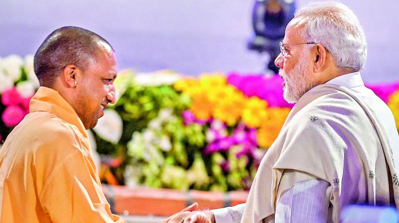 Prime Minister Narendra Modi being welcomed by Uttar Pradesh Chief Minister Yogi Adityanath at the launch of various developmental projects, in Lucknow on Sunday. (Photo: PTI)