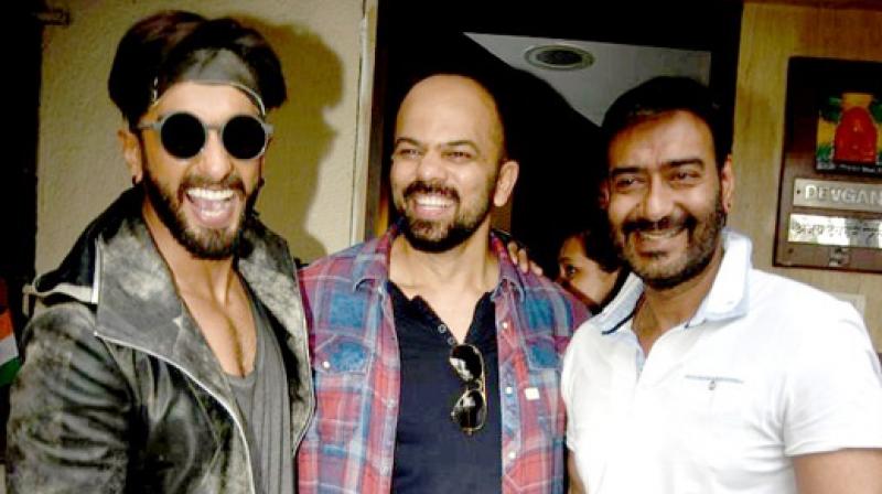 Ranveer Singh, Rohit Shetty and Ajay Devgn pose for the camera.