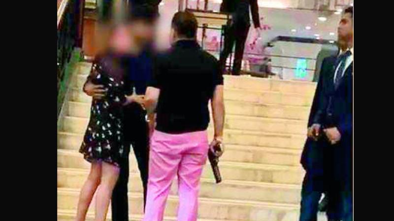 Ashish Pandey holds a pistol as he argues with a woman and her friend.