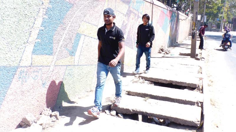 The broken slabs of the footpath on the Gangadhar Chetty Road. (Photo: R. Samuel)