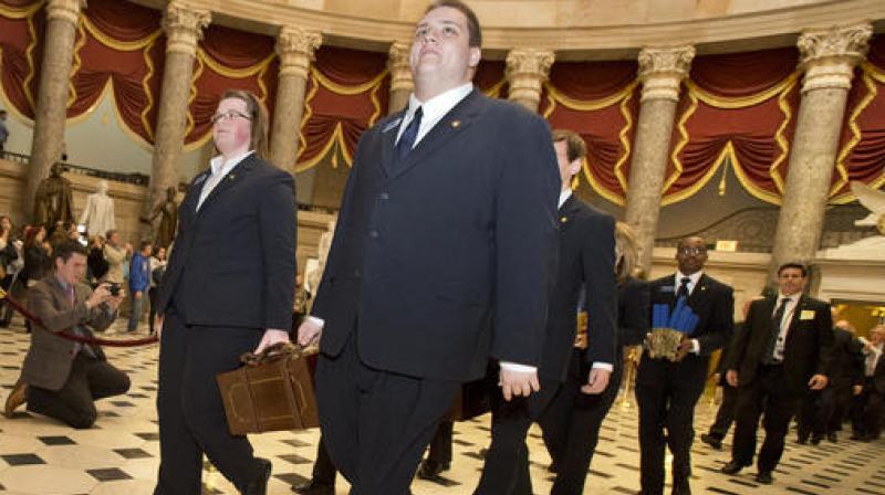 A Senate procession carrying two boxes holding Electoral College votes through Statuary Hall to the House Chamber on Capitol Hill on Capitol Hill in Washington. (Photo: AP)