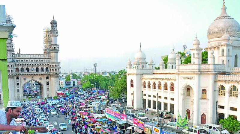 A worker installs a CCTV camera near Macca Masjid on Saturday. 	(Photo: DC)