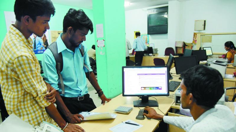 Applicants wait to register for DOST, the online degree college admission system, at a Mee Seva centre at Pat-ny, Secunderabad, where the server was down. DC
