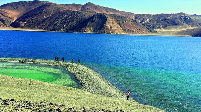 Ladakhs amazing  vari-coloured mountains form a frame for the blue waters of Pangong Lake.
