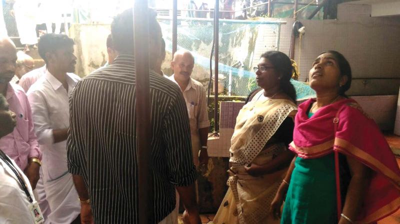 Kozhikode DMO Dr Jayashree (second from right)  visits the buildings at Mavoor on Monday. (Photo: DC)