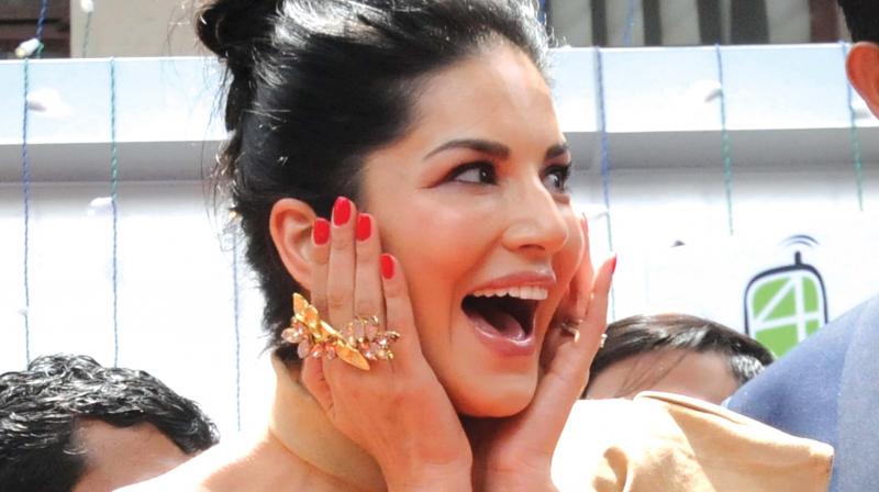 Actor Sunny Leone reacts in awe as huge crowds jostled to catch a glimpse of her in Kochi on Thursday. The popular actor was in the city for the launch of a new shop of a mobile phone retailer. (Photo: ARUN CHANDRABOSE)