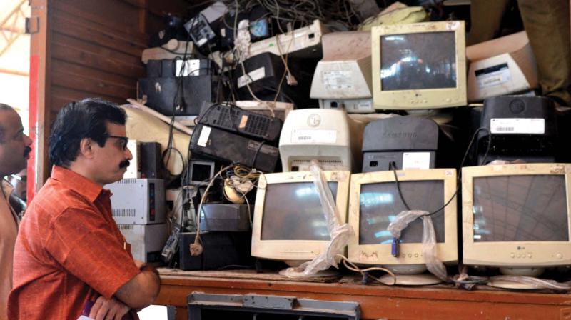 Education minister C. Raveendranath takes a look at the  E-waste collected from schools after a collection  programme at GGHSS Cotton Hill in Thiruvananthapuram, Nearly three tonnes of E waste was collected from city schools in the city. 	(Photo: DC)
