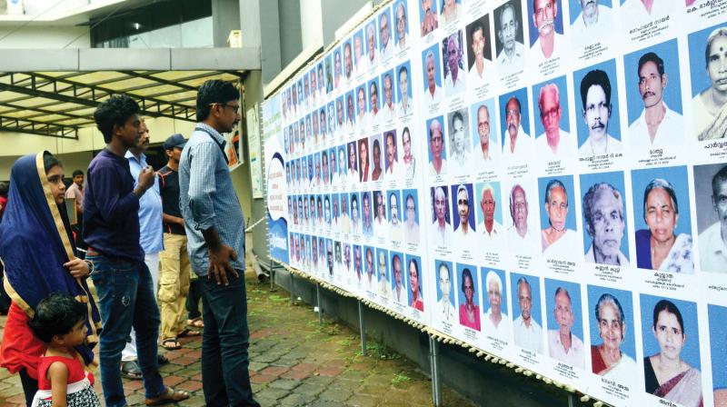 Visitors watch the photographs in front of the hospital.