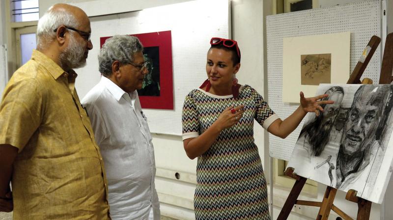 Russian painter Maltseva Evgeniya introduces her work to CPI(M) general secretary Sitaram Yechury and CPM politburo member M.A. Baby.