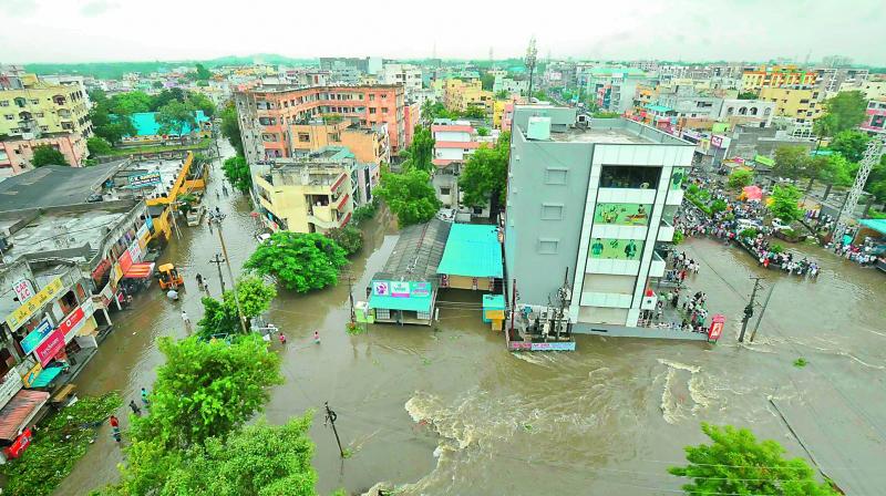 An aerial view of submerged Nacharam, after heavy overnight rains on Wednesday. Residents of the area have been complaining that everytime it rains, the main nala overflows and floods the areas, yet authorities refuse to take necessary steps. 	(Pix by Gandhi and S.Surender Reddy )