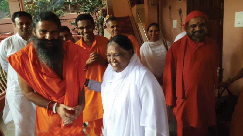 Baba Ramdev meets Matha Amritanandamayi at her ashram in Amritapuri on Tuesday. (Photo:  DC)