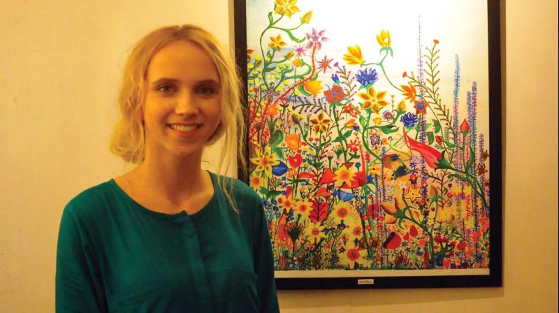 Weera Kulppi with the painting at the exhibition.  	DC