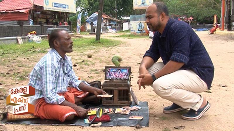 Biju Muthathi interviewing a fortune teller in the Oachira temple premises.