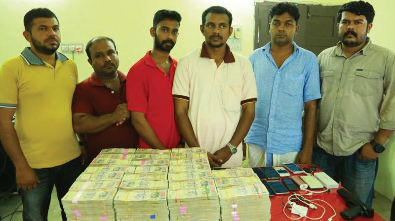 The  notes in Rs 1,000 denomination were hidden in two cars. They were caught by special squad  led by DySP M.P. Mohanachandran following a tip-off.