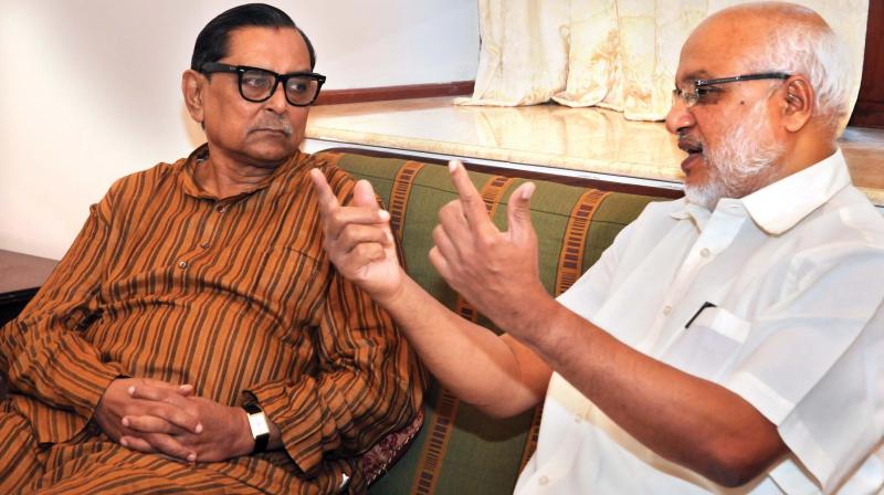 Bangladesh tourism minister and trade union leader Rashed Khan Menon chats with CPM politburo member M.A. Baby in Kochi on Friday. 	(Photo: ARUNCHANDRA BOSE)
